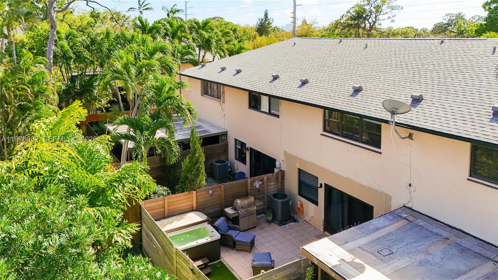2128 Northeast 9th Avenue Wilton Manors, FL 33305 - Photo 34 of 34 a view of a patio with table and chairs with wooden fence