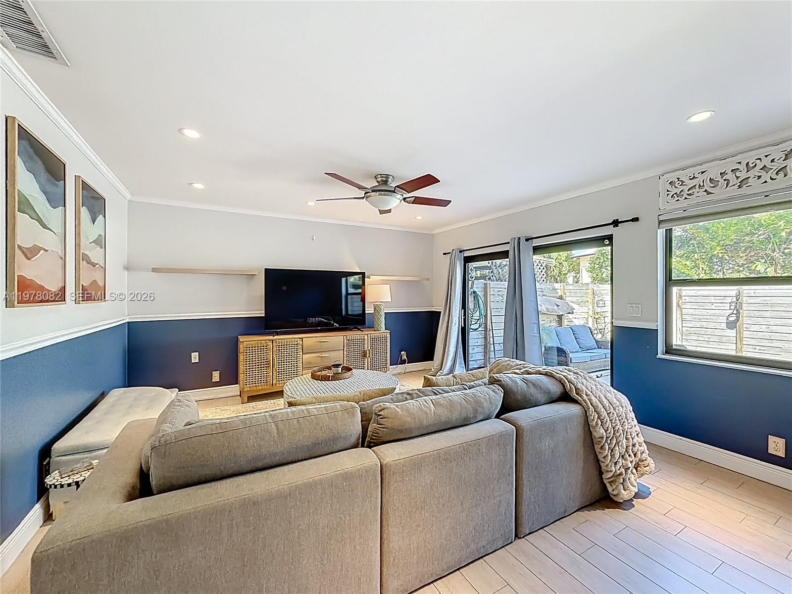 2128 Northeast 9th Avenue Wilton Manors, FL 33305 - Photo 9 of 34 a living room with furniture and a flat screen tv