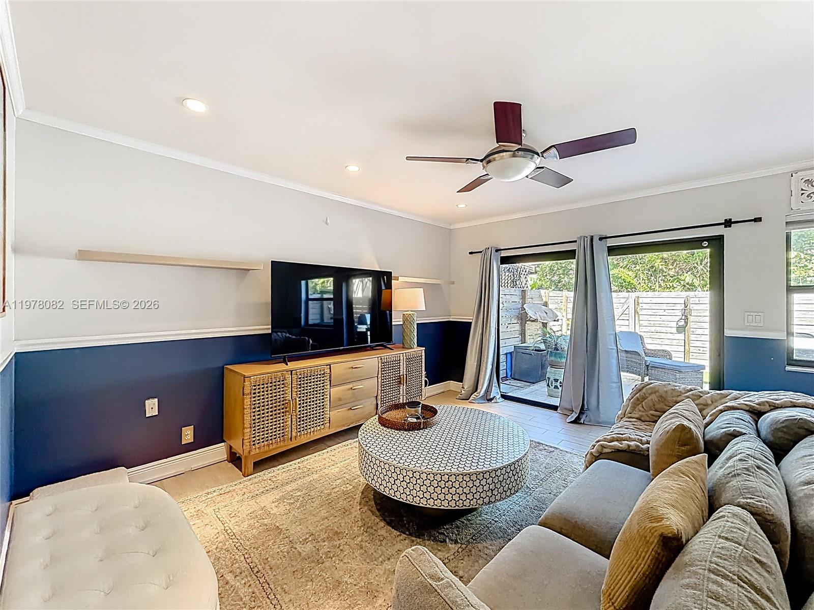 2128 Northeast 9th Avenue Wilton Manors, FL 33305 - Photo 10 of 34 a living room with furniture and a flat screen tv