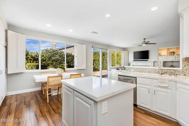 a view of a kitchen with a sink and living room