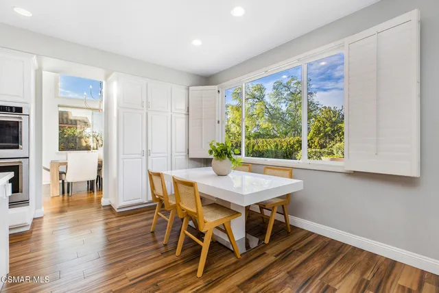 a view of a dining room with furniture window and wooden floor
