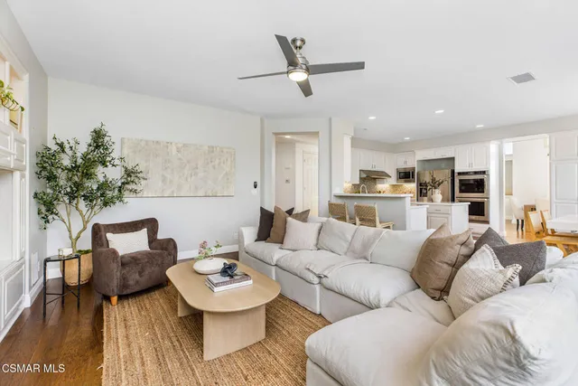 a living room with furniture and kitchen view