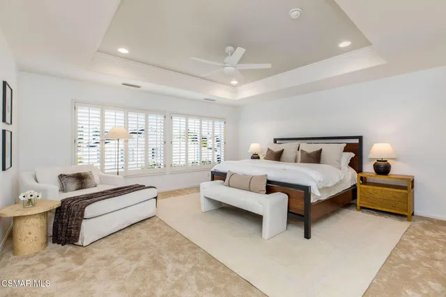 a spacious bedroom with a bed and a couch