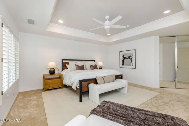 a bedroom with bed and night stand