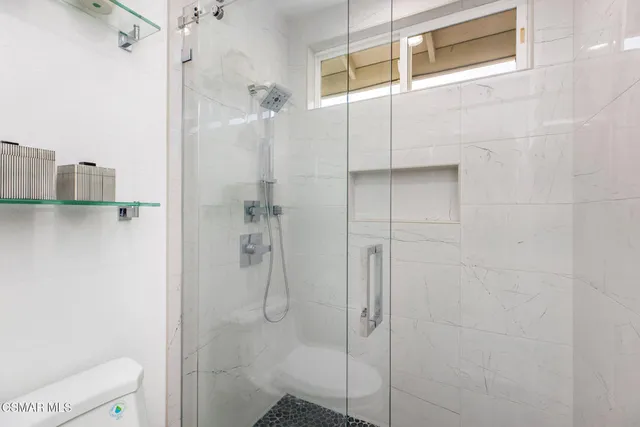 a bathroom with a shower and toilet
