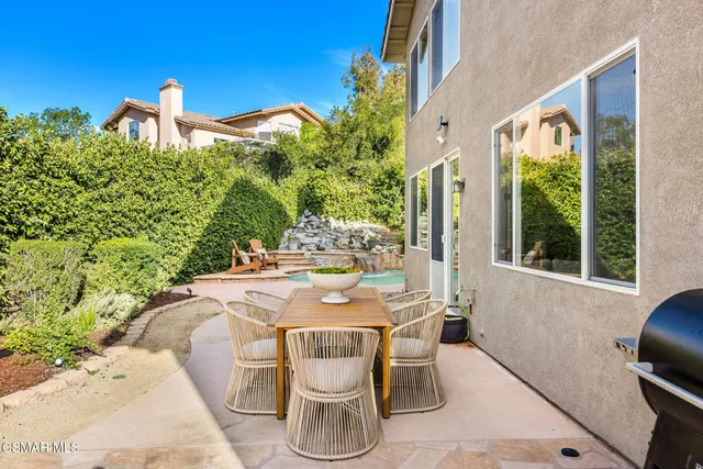 a view of a dining table and chairs in the patio
