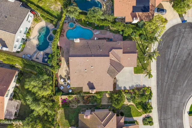 an aerial view of a house with a yard and garden