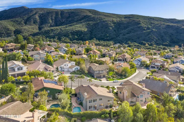 an aerial view of residential houses with outdoor space