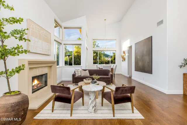 a living room with furniture a fireplace and a table
