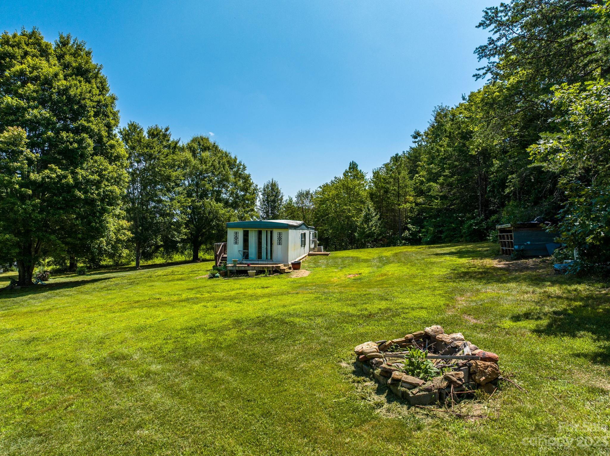 936 Goble Road Hiddenite, NC 28636 - Photo 11 of 32 a backyard of a house with lots of green space