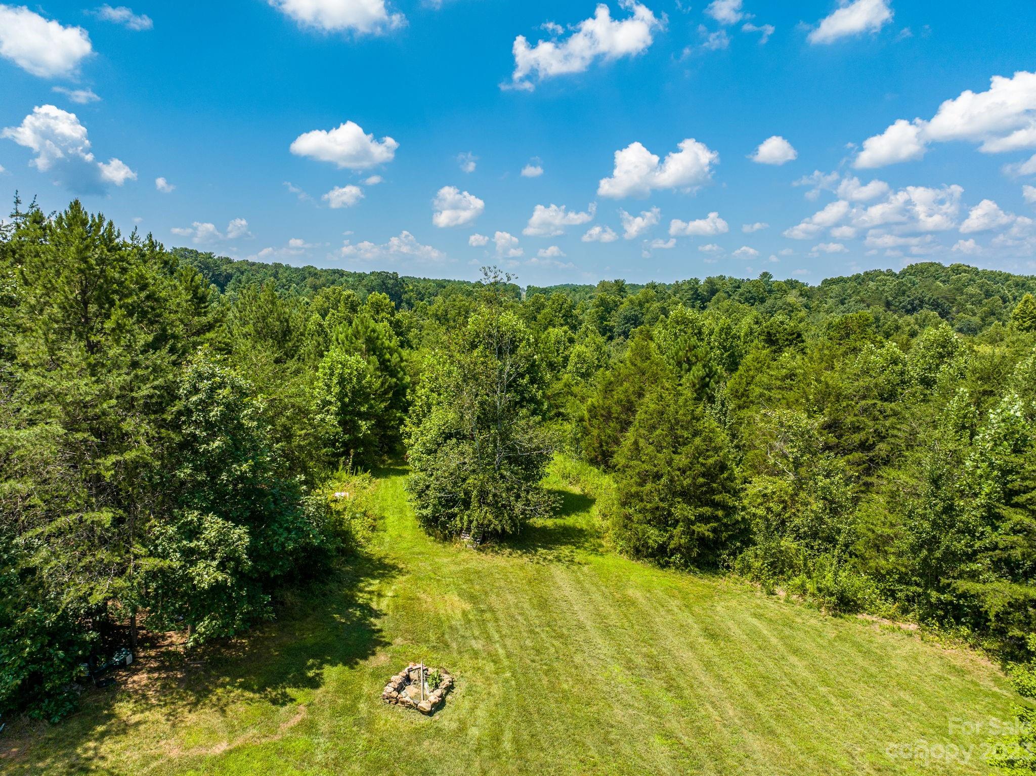 936 Goble Road Hiddenite, NC 28636 - Photo 14 of 32 a view of a big yard with lots of green space