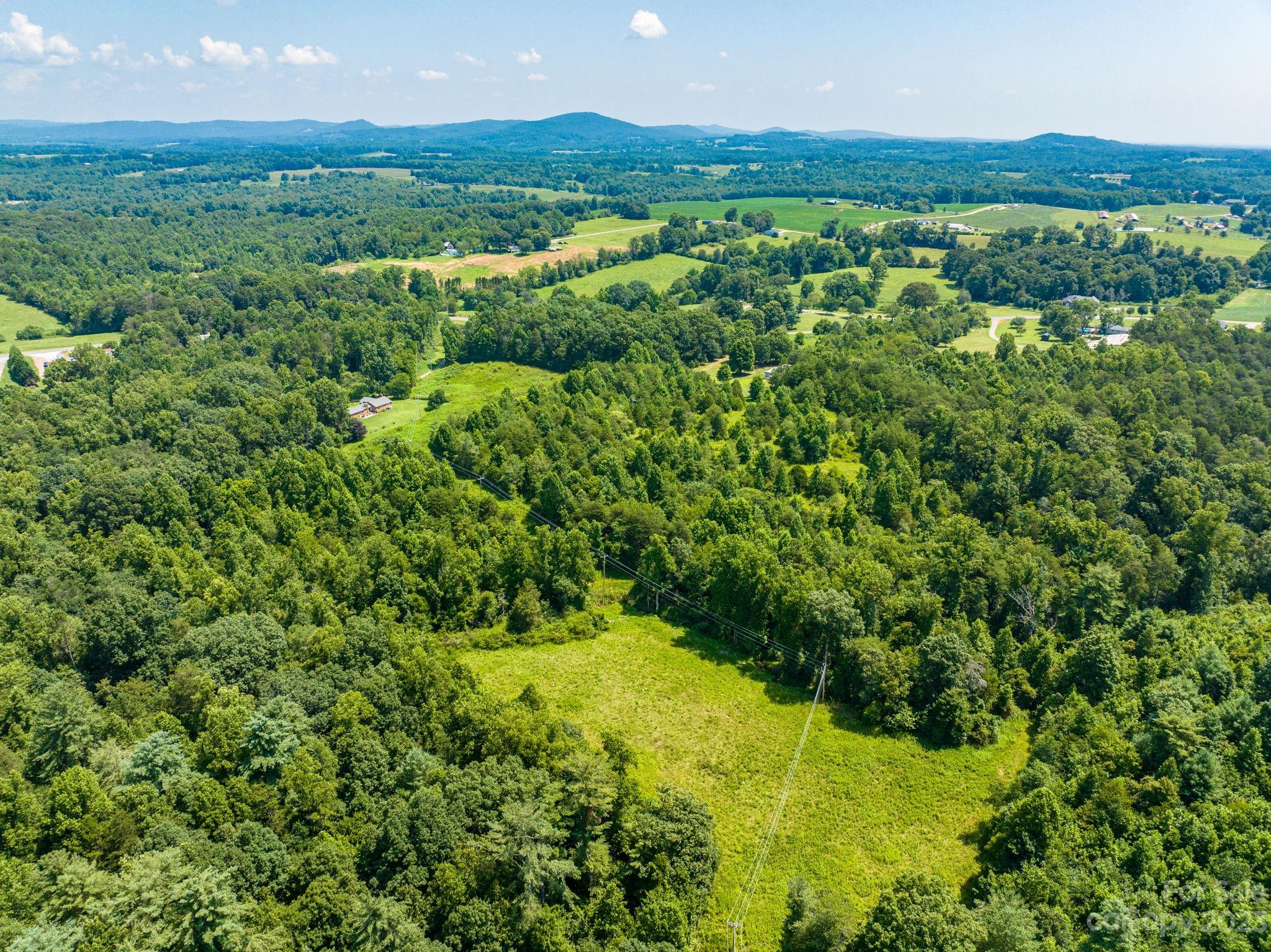 936 Goble Road Hiddenite, NC 28636 - Photo 20 of 32 a view of a lush green forest with houses
