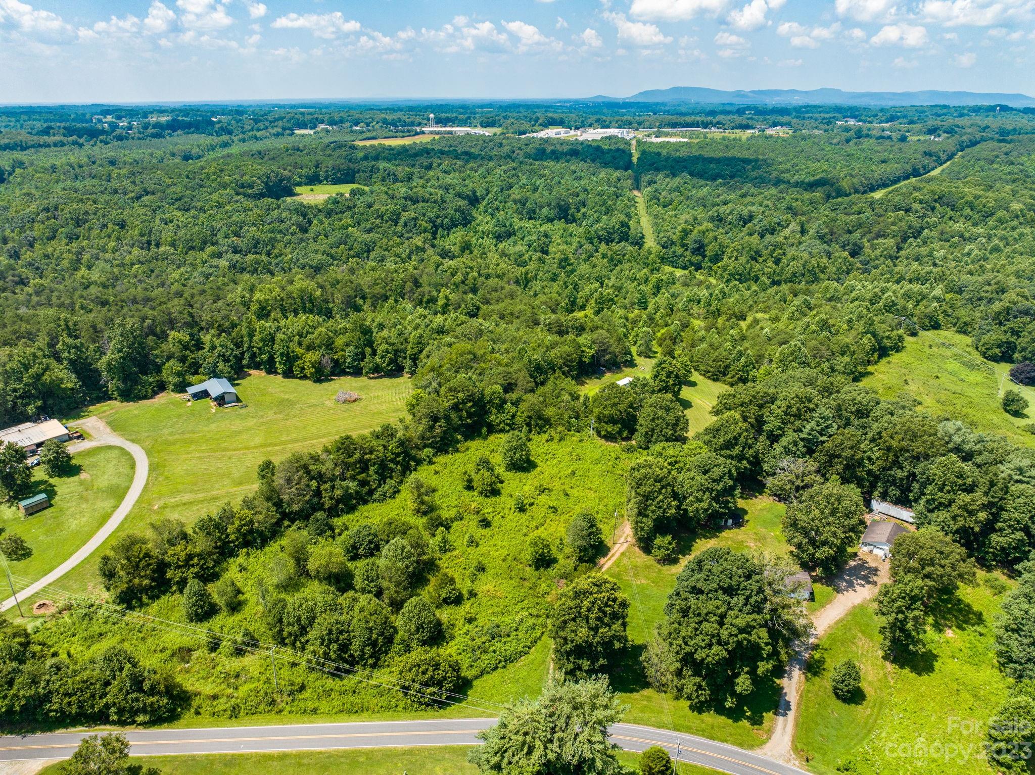 936 Goble Road Hiddenite, NC 28636 - Photo 24 of 32 a view of a big yard with large trees