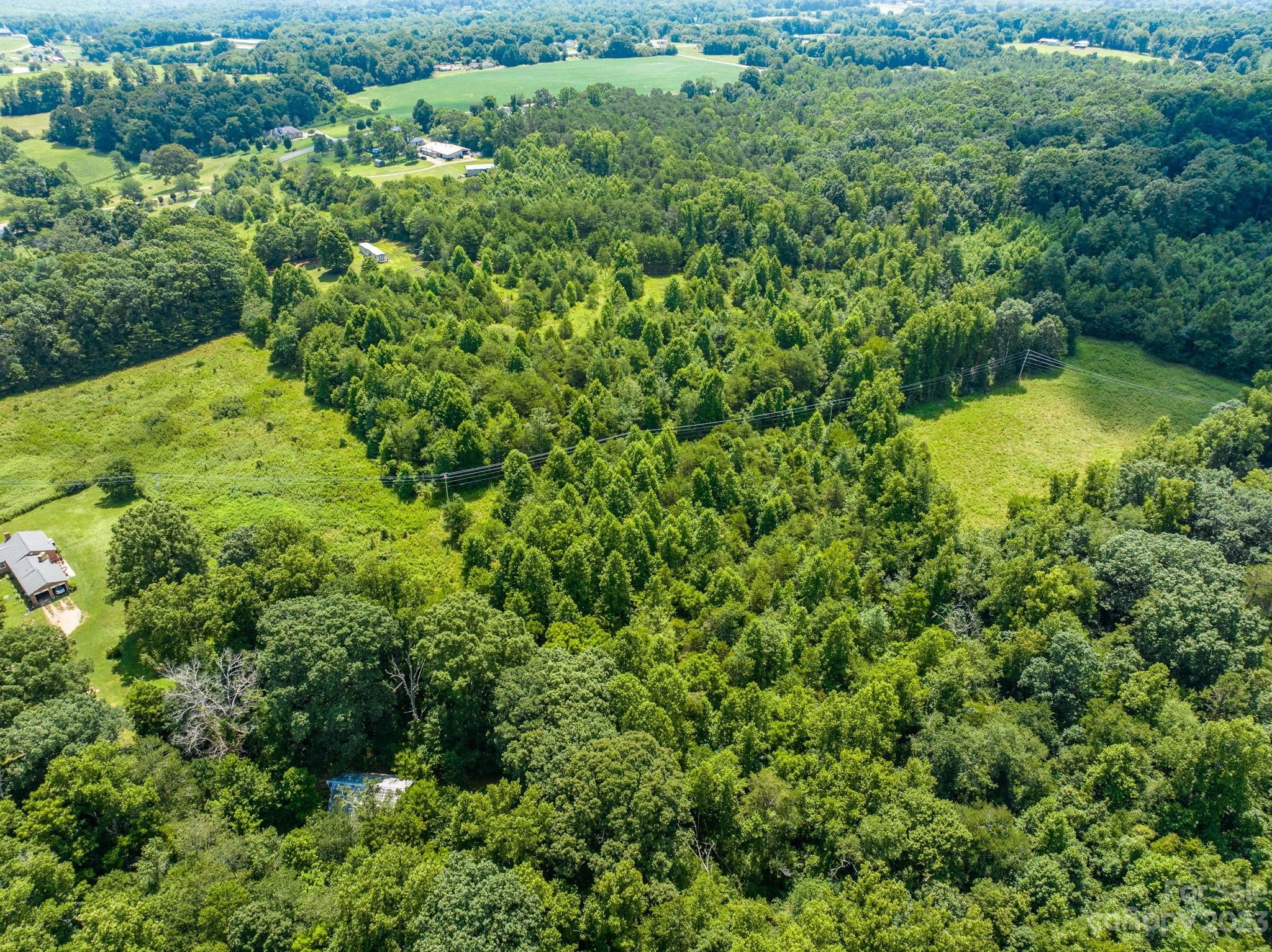 936 Goble Road Hiddenite, NC 28636 - Photo 26 of 32 an aerial view of residential house with outdoor space and trees all around