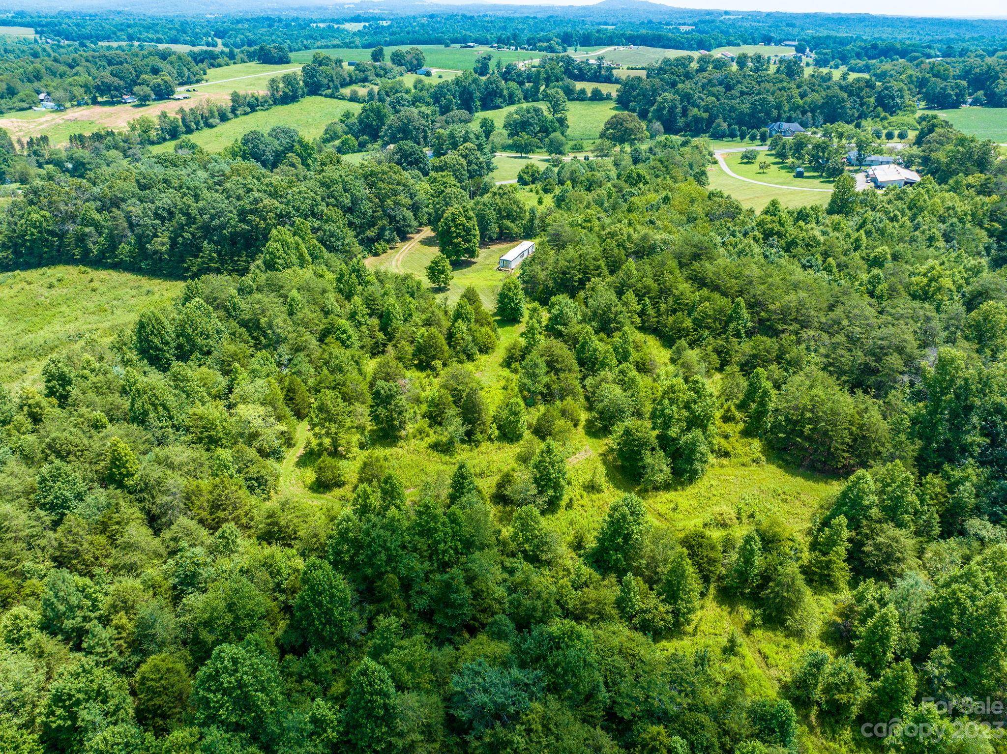 936 Goble Road Hiddenite, NC 28636 - Photo 27 of 32 a view of a lush green forest with houses