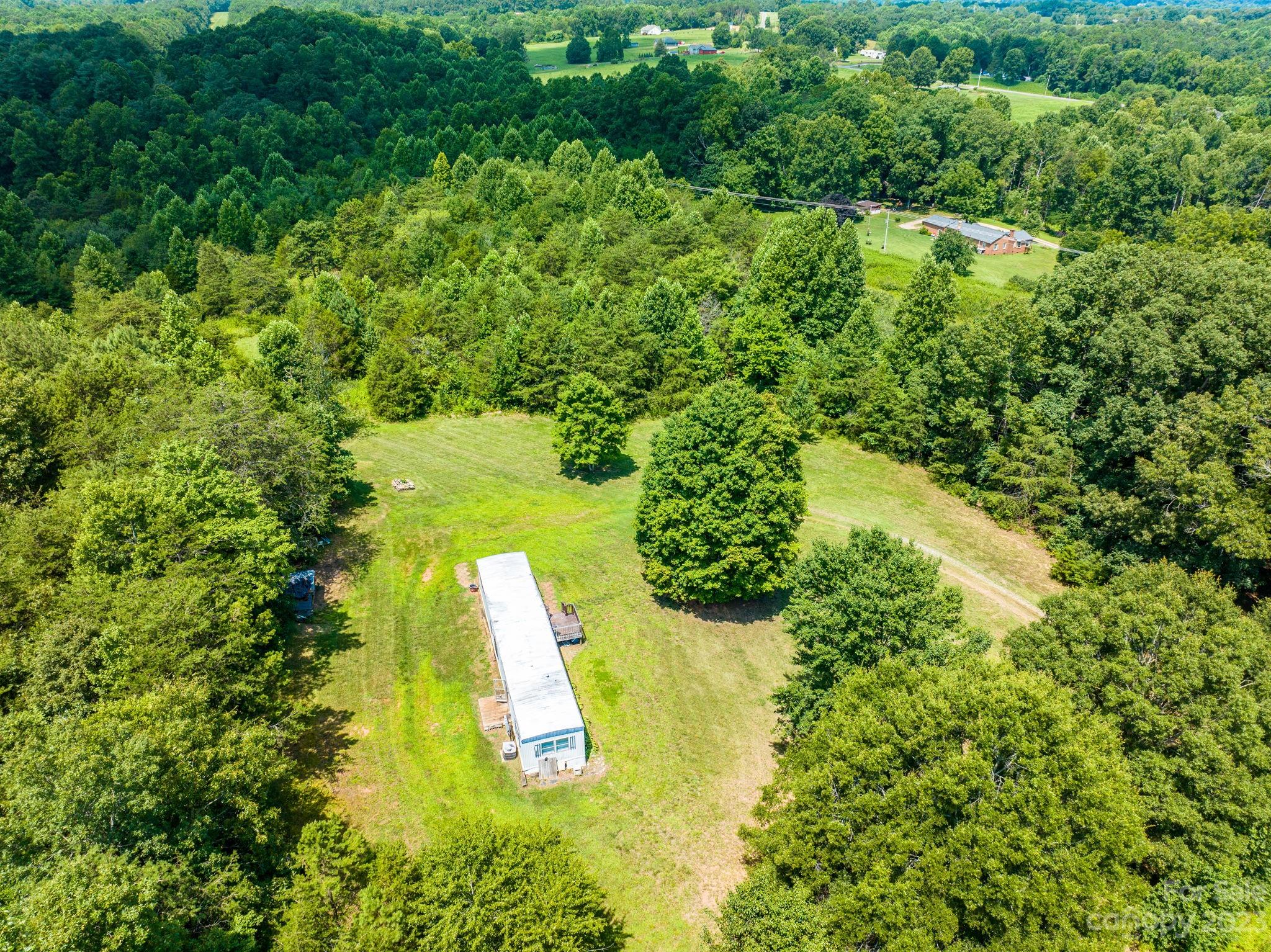 936 Goble Road Hiddenite, NC 28636 - Photo 29 of 32 an aerial view of a residential houses with yard and swimming pool