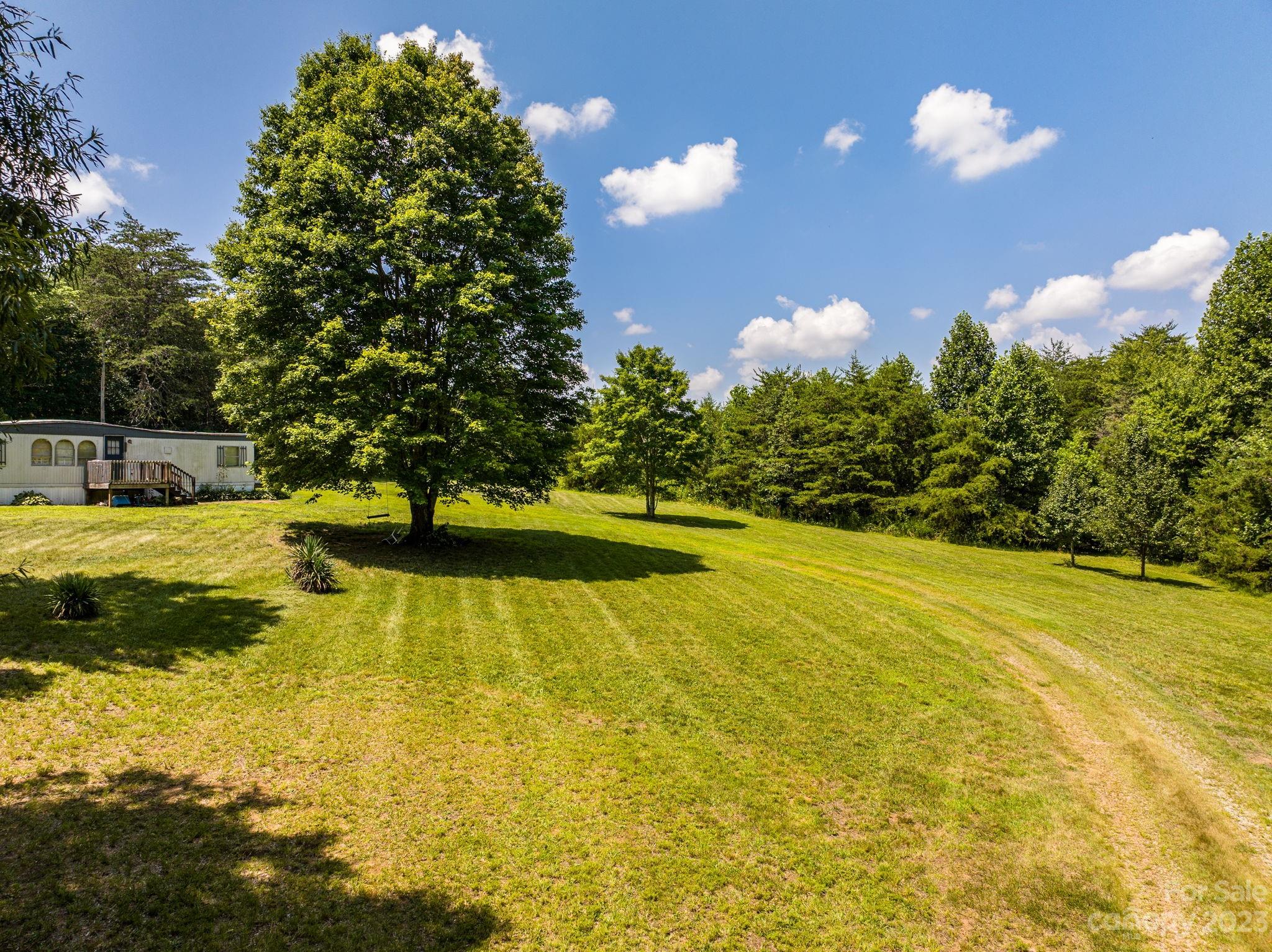 936 Goble Road Hiddenite, NC 28636 - Photo 7 of 32 a view of a swimming pool with an outdoor space and seating area