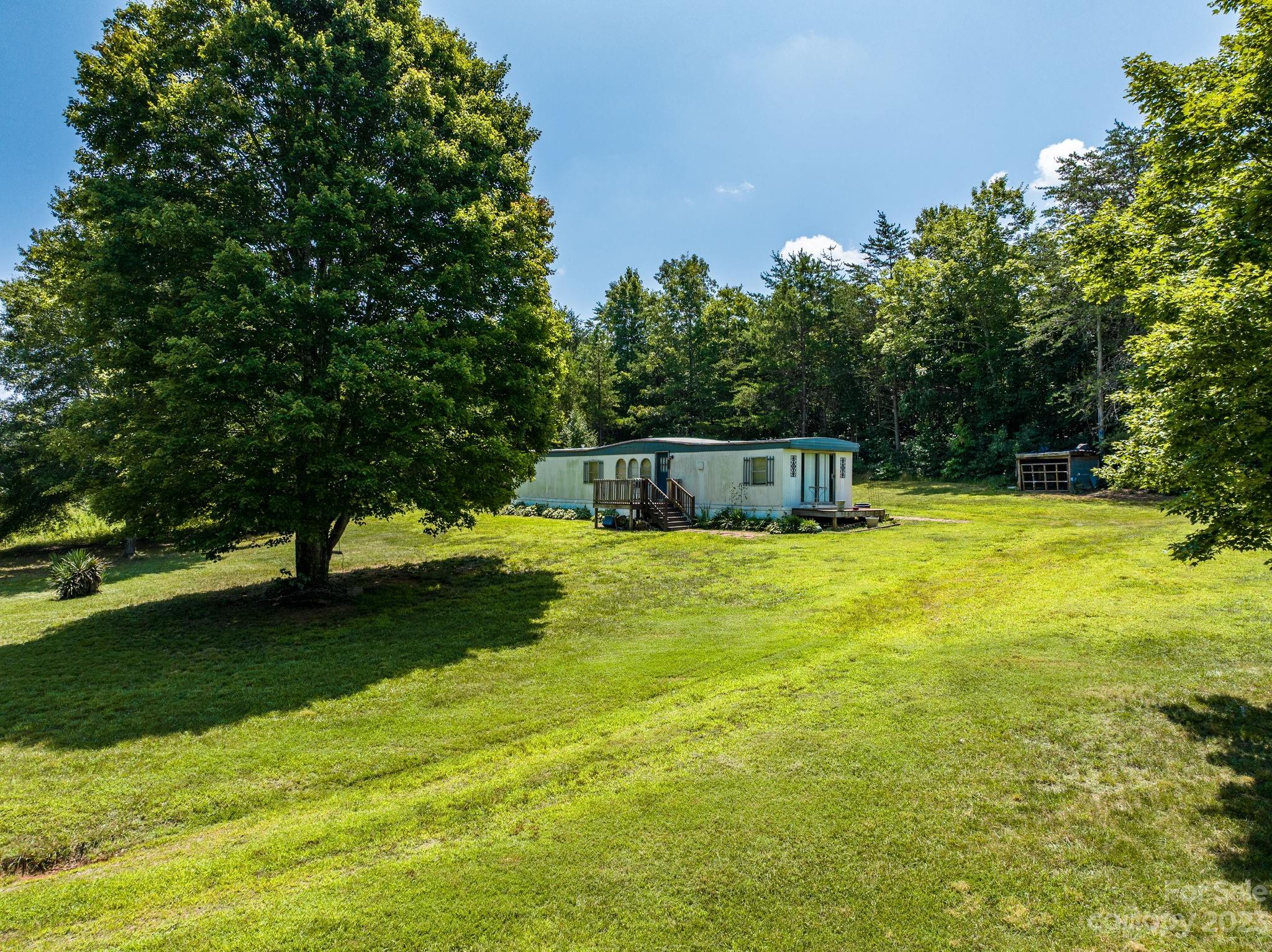 936 Goble Road Hiddenite, NC 28636 - Photo 9 of 32 a view of a swimming pool with a garden