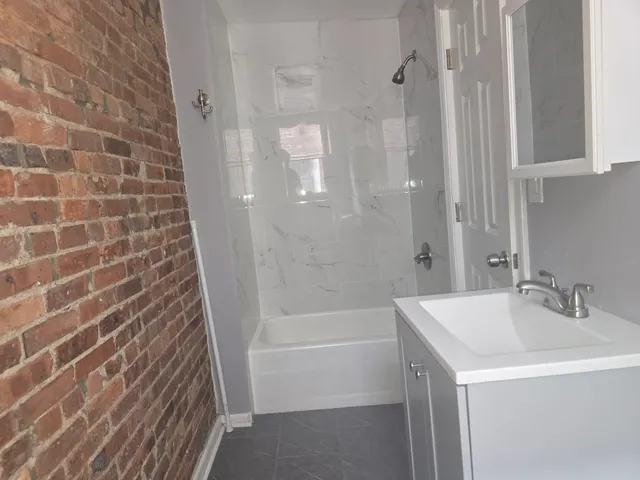 a bathroom with a shower and a sink