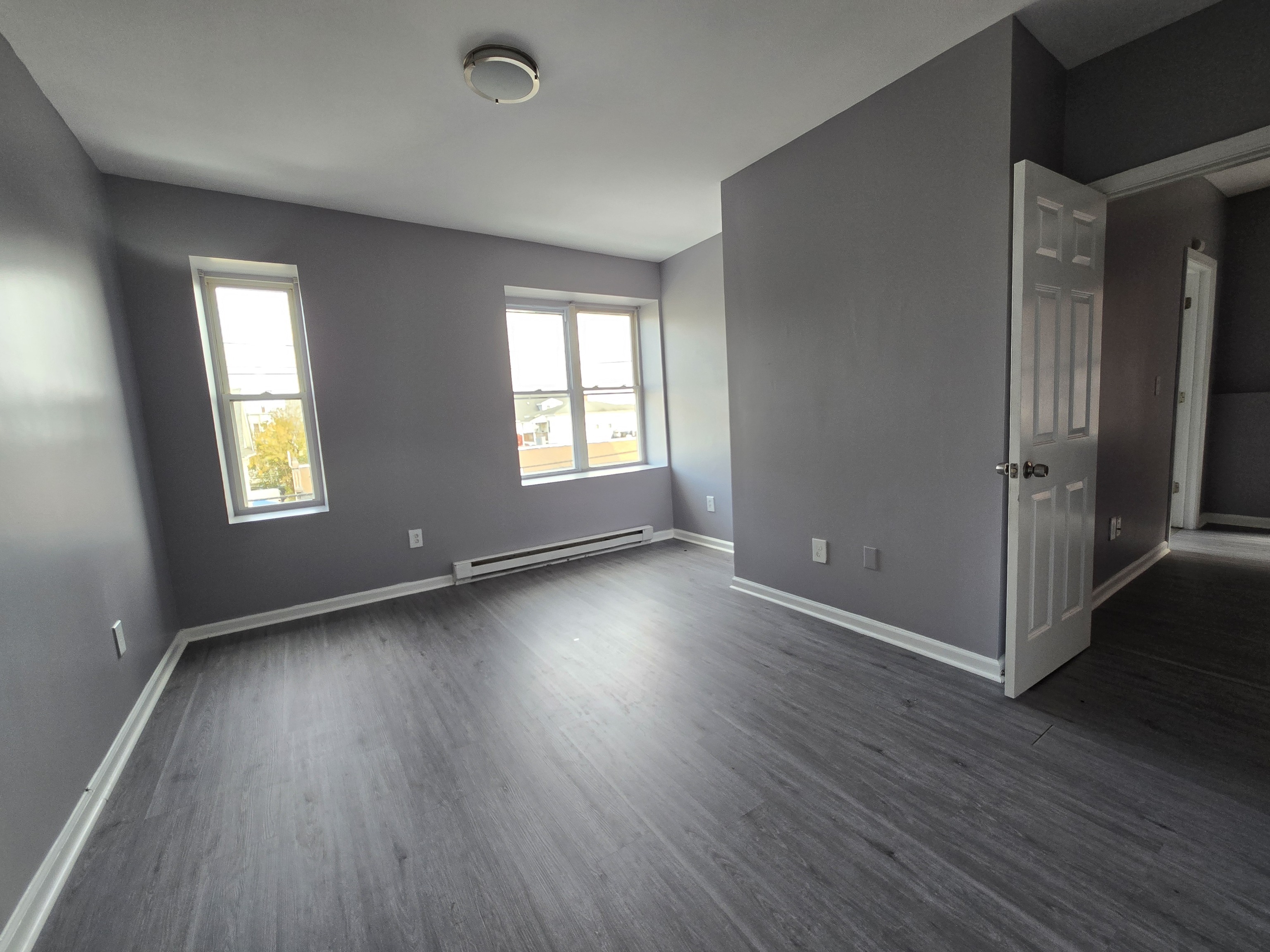 31 Whittier Street, Unit 3A Bridgeport, CT 06605 - Photo 5 of 5 an empty room with wooden floor and windows