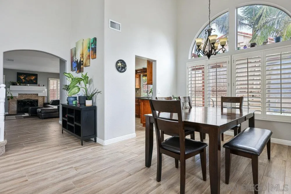790 Mosaic Circle Oceanside, CA 92057 - Photo 21 of 47 a dining room with furniture a floor to ceiling window and wooden floor