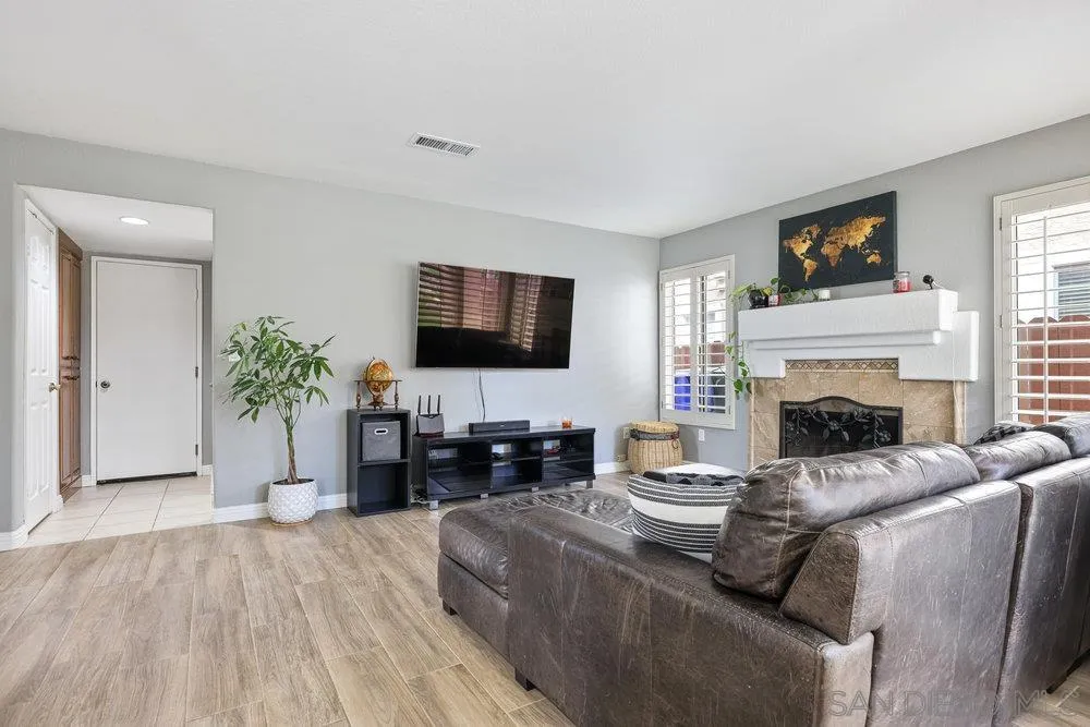790 Mosaic Circle Oceanside, CA 92057 - Photo 25 of 47 a living room with furniture a fireplace and a flat screen tv