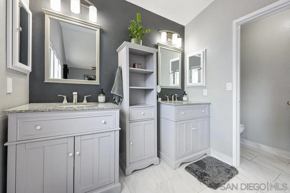 790 Mosaic Circle Oceanside, CA 92057 - Photo 40 of 47 a spacious bathroom with a granite countertop sink and a mirror