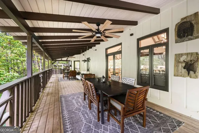 a view of balcony with wooden floor and fence