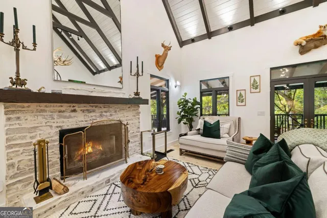 a living room with furniture and kitchen view