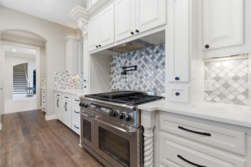 8970 Burnett Road Justin, TX 76247 - Photo 12 of 39 a kitchen with white cabinets and appliances