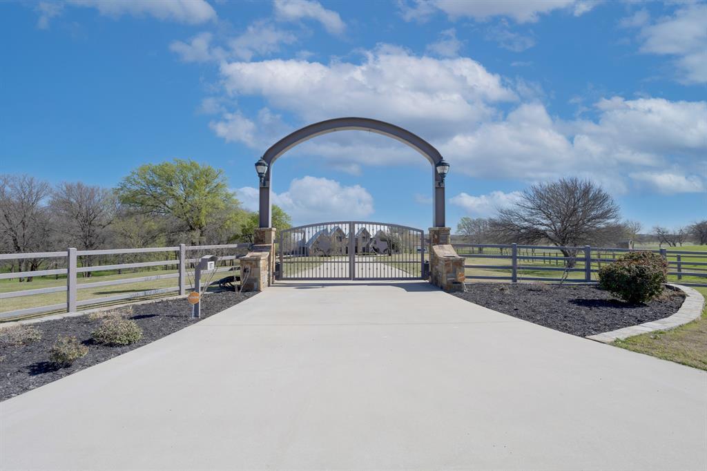 8970 Burnett Road Justin, TX 76247 - Photo 2 of 39 a view of a garden with large trees