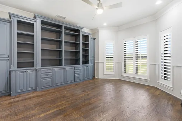 a view of wooden floor and windows in a room