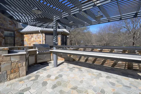 a kitchen with stainless steel appliances kitchen island granite countertop a sink a stove a counter top space and cabinets