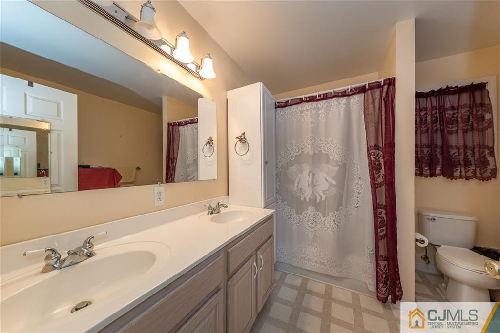 132 Launch Road Manahawkin, NJ 08050 - Photo 12 of 25 a bathroom with a double vanity sink toilet and shower