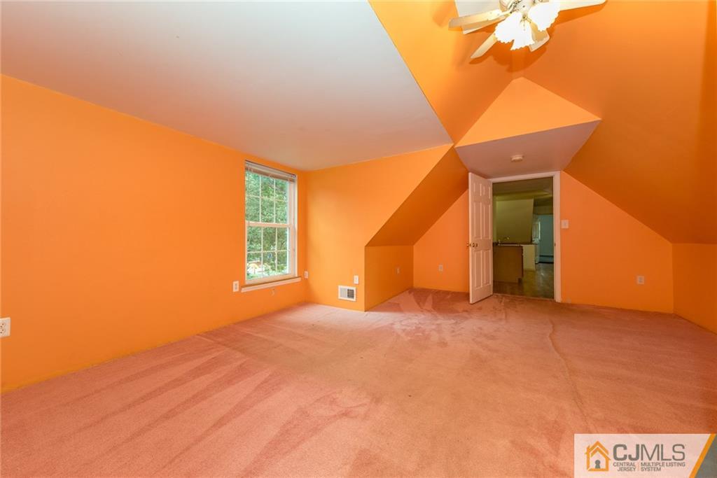 132 Launch Road Manahawkin, NJ 08050 - Photo 17 of 25 a view of a big room with windows and a ceiling fan