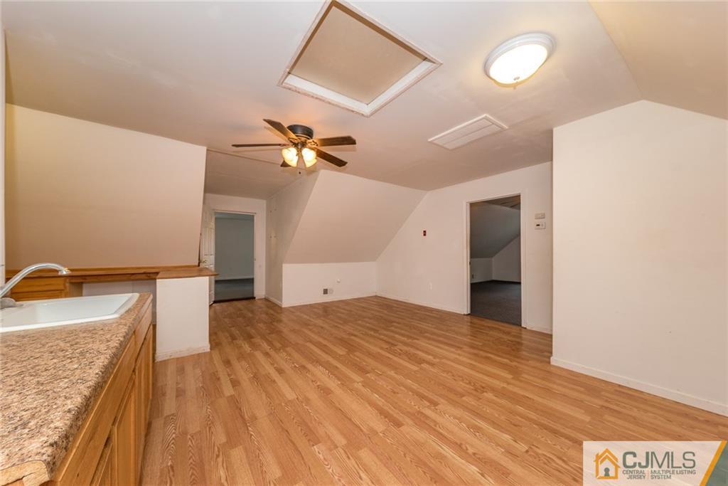 132 Launch Road Manahawkin, NJ 08050 - Photo 19 of 25 a view of a kitchen with a sink hardwood floor and a ceiling fan