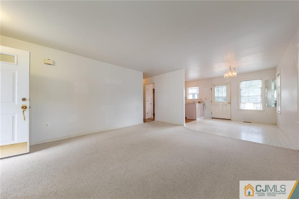 132 Launch Road Manahawkin, NJ 08050 - Photo 3 of 25 a view of a big room with windows and chandelier fan