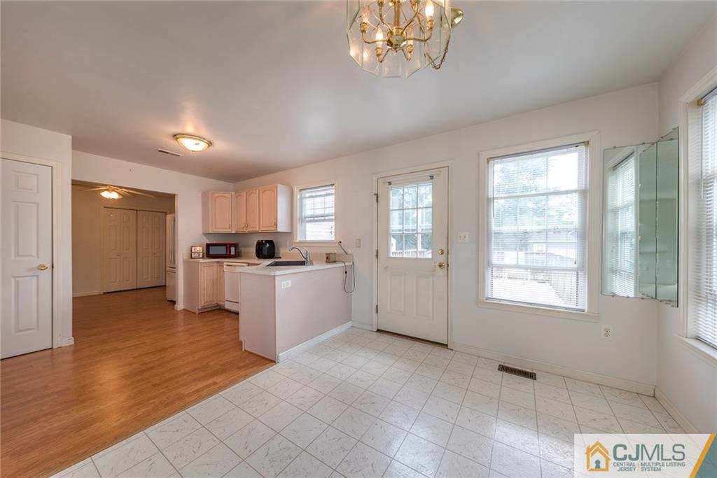 132 Launch Road Manahawkin, NJ 08050 - Photo 4 of 25 a view of a kitchen with microwave and windows