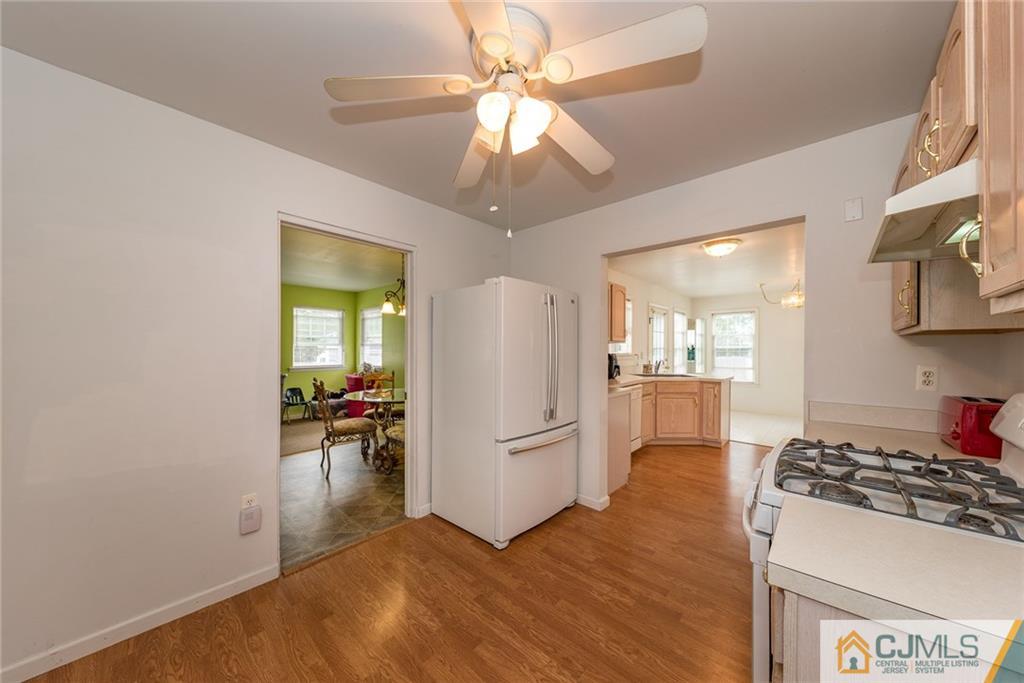132 Launch Road Manahawkin, NJ 08050 - Photo 7 of 25 a kitchen with a refrigerator and a stove top oven