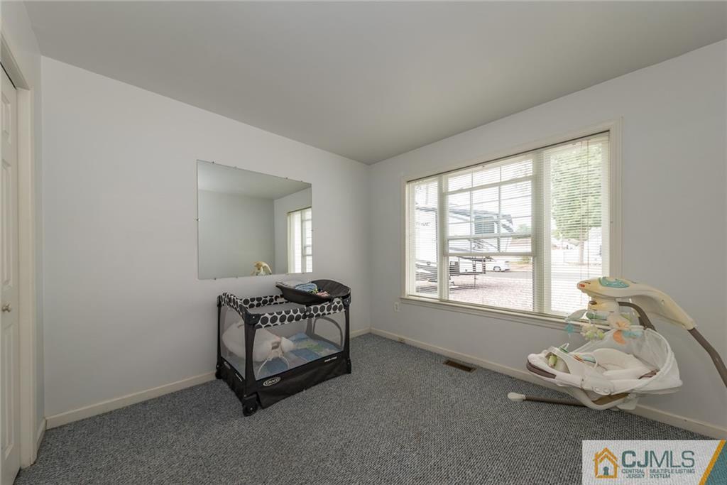 132 Launch Road Manahawkin, NJ 08050 - Photo 9 of 25 a room with a bed and a window