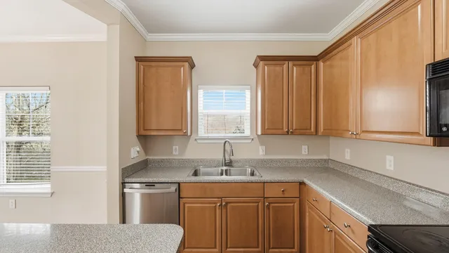 a kitchen with a sink cabinets and window