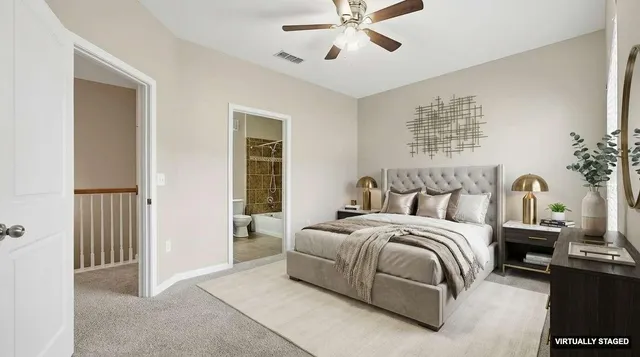 a bedroom with a large bed and a chandelier