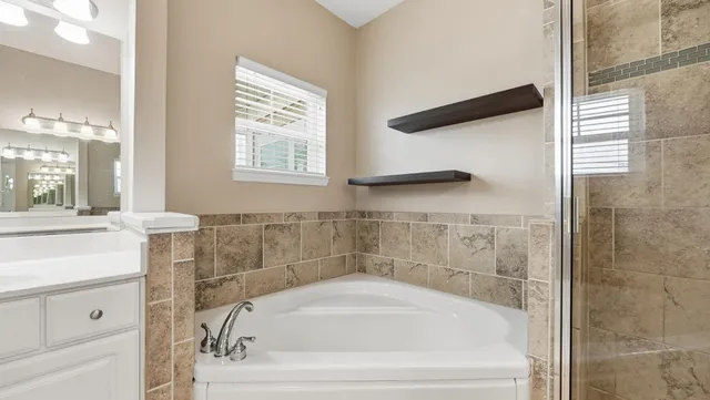 a white bath tub sitting next to a white sink