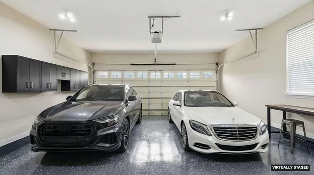 a kitchen with stainless steel appliances a stove and white cabinets