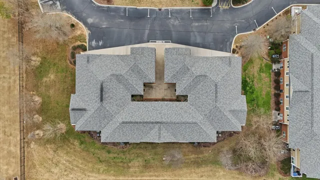 a bathroom with a granite countertop shower and a mirror