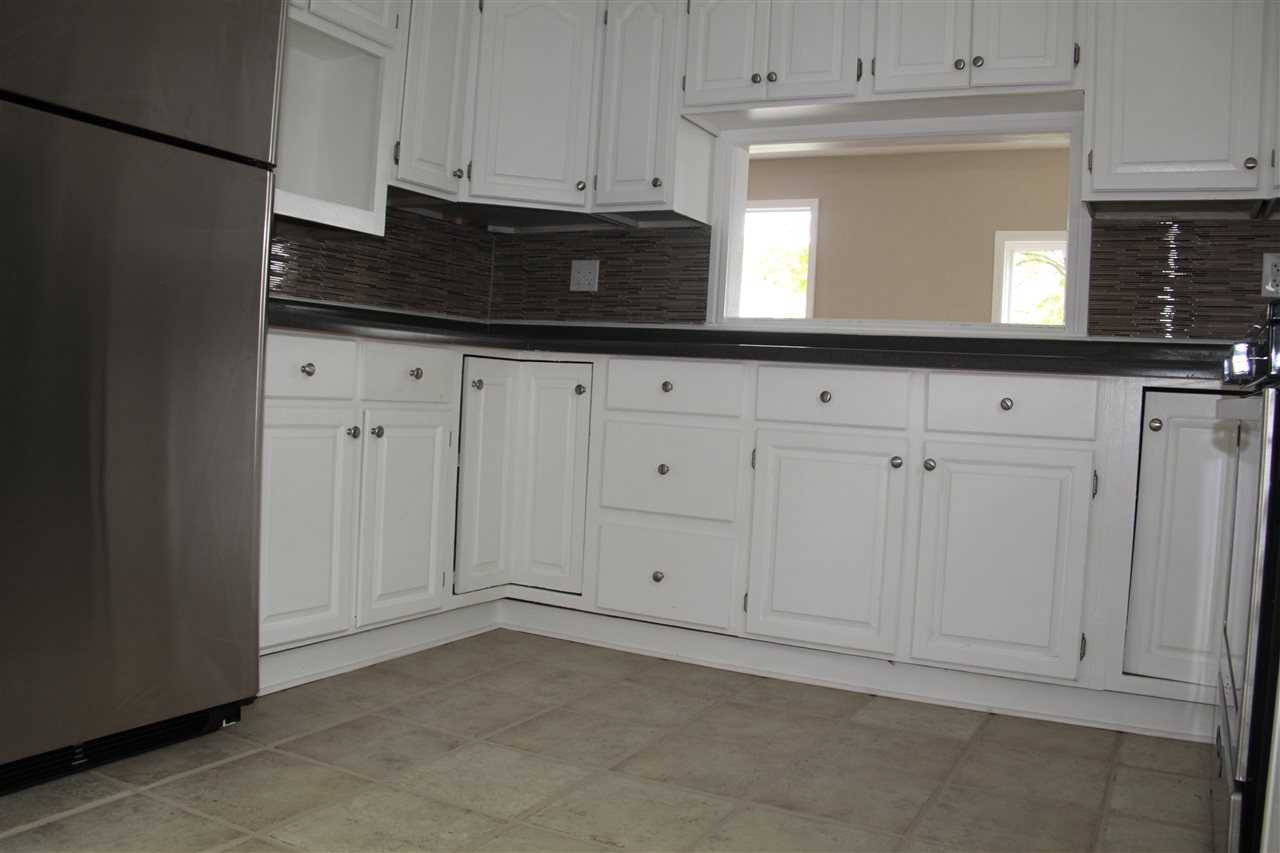 3618 Rotary Road Rockford, IL 61109 - Photo 11 of 24 a kitchen with granite countertop white cabinets and sink