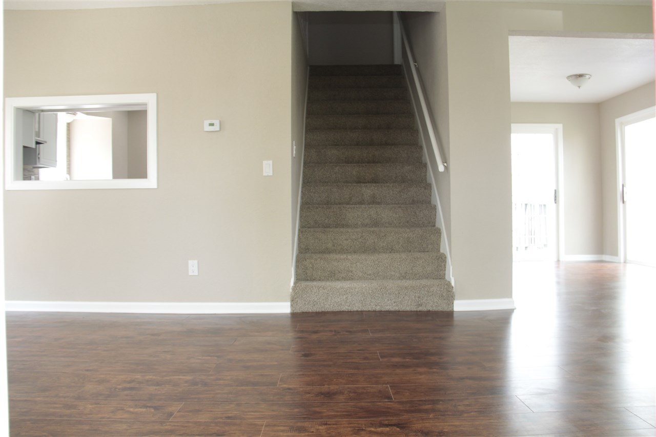 3618 Rotary Road Rockford, IL 61109 - Photo 5 of 24 a view of an empty room with wooden floor and a window