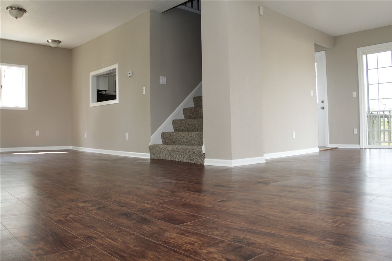3618 Rotary Road Rockford, IL 61109 - Photo 6 of 24 a view of an empty room with wooden floor and a window