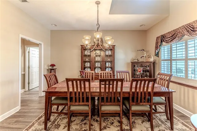a kitchen with kitchen island granite countertop a sink stove and cabinets