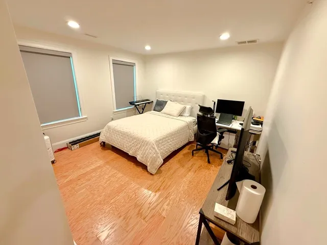 a bedroom with a bed and a chair
